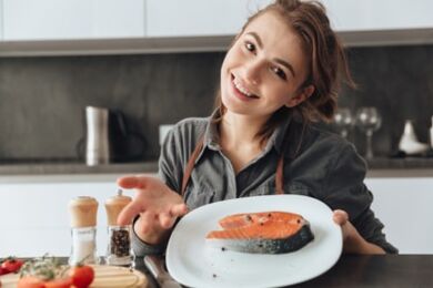 Young girl with a trout steak
